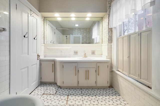 bathroom featuring vanity, shower / bathtub combination, and decorative backsplash