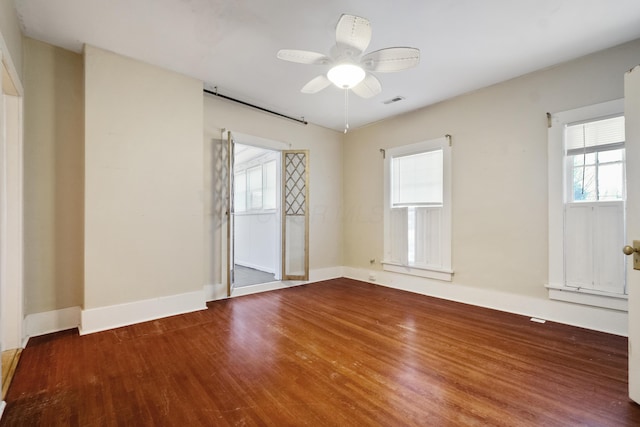 spare room featuring hardwood / wood-style floors, plenty of natural light, and ceiling fan