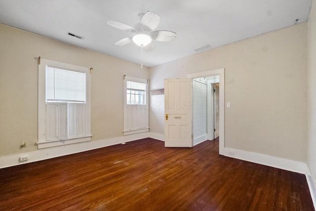 unfurnished room featuring ceiling fan and dark wood-type flooring