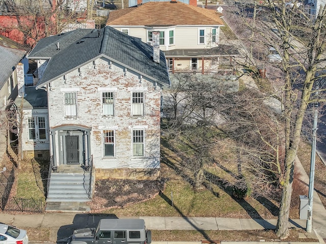 view of front of property featuring roof with shingles