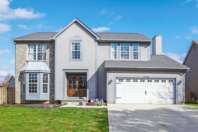 view of front of house with a garage and a front yard