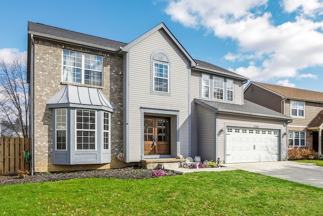 view of front of home with a garage and a front lawn