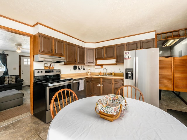 kitchen featuring a textured ceiling, sink, and stainless steel appliances