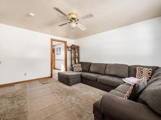 living room with ceiling fan, carpet, and a textured ceiling