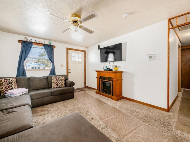 carpeted living room featuring a textured ceiling and ceiling fan