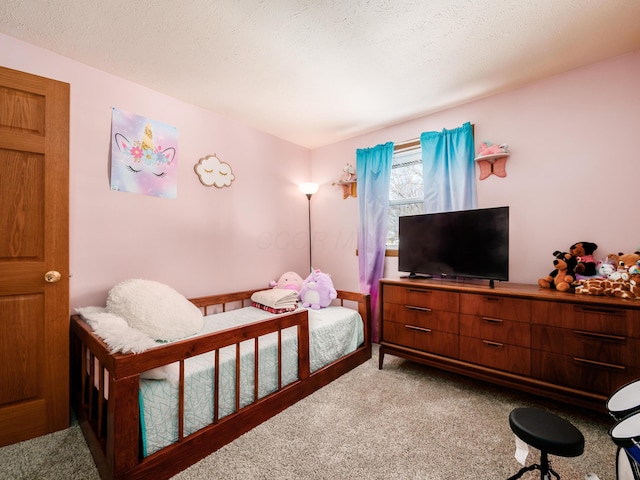 bedroom with a textured ceiling and carpet floors