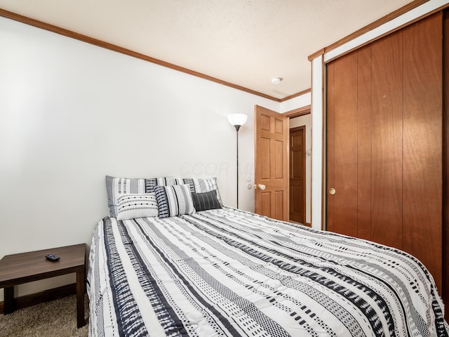 carpeted bedroom featuring ornamental molding and a closet