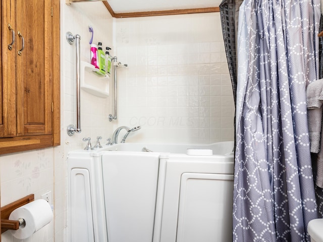 bathroom with toilet, plus walk in shower, tile walls, and ornamental molding