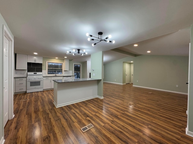 kitchen featuring kitchen peninsula, range, white cabinetry, and dark wood-type flooring