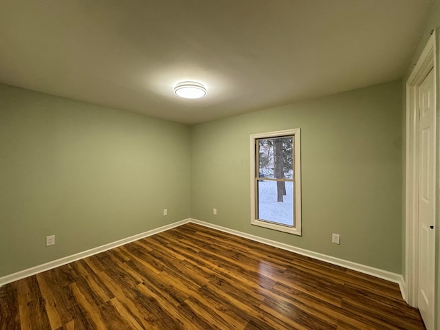 unfurnished bedroom with dark hardwood / wood-style flooring