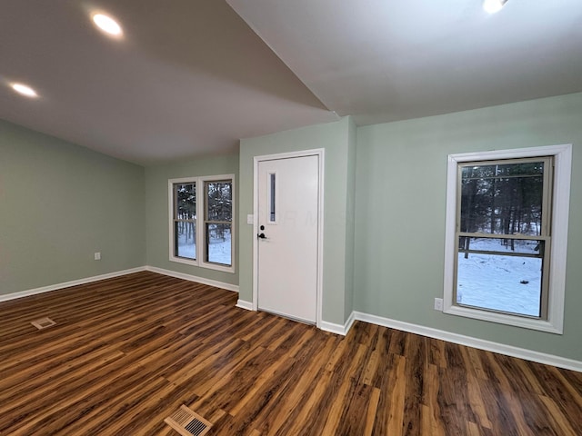 empty room with dark hardwood / wood-style flooring