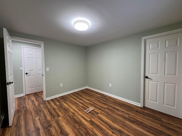 spare room with dark hardwood / wood-style flooring