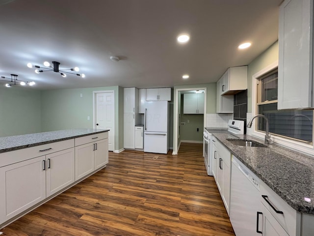 kitchen with white cabinets, white appliances, and sink