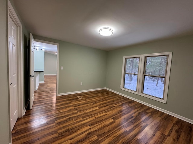 spare room featuring dark hardwood / wood-style flooring