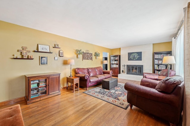 living room with a fireplace and hardwood / wood-style floors