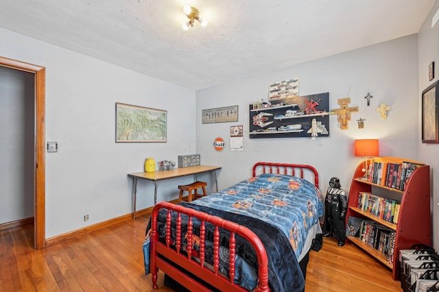 bedroom with hardwood / wood-style flooring