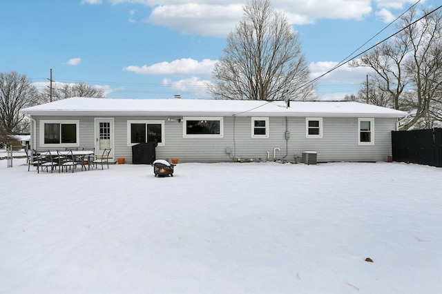 snow covered back of property with central AC unit