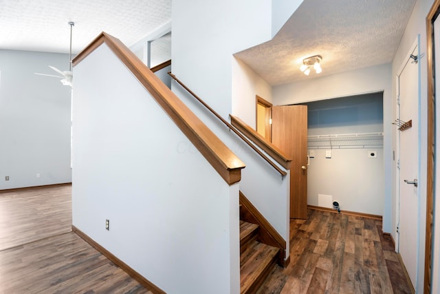 staircase with wood-type flooring, a textured ceiling, and ceiling fan