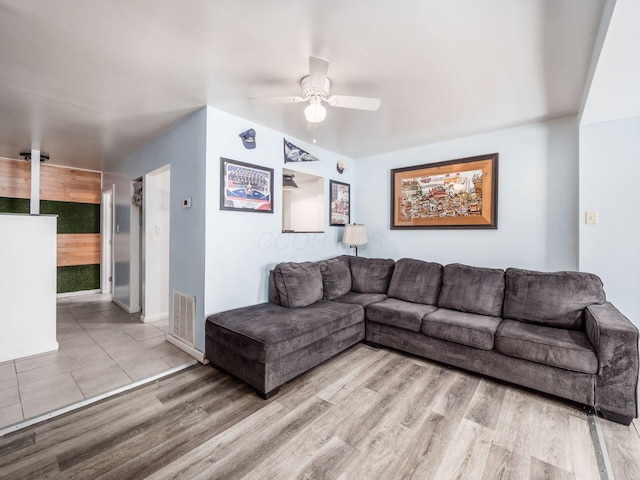 living room featuring ceiling fan and light wood-type flooring