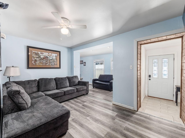 living room featuring ceiling fan and light wood-type flooring