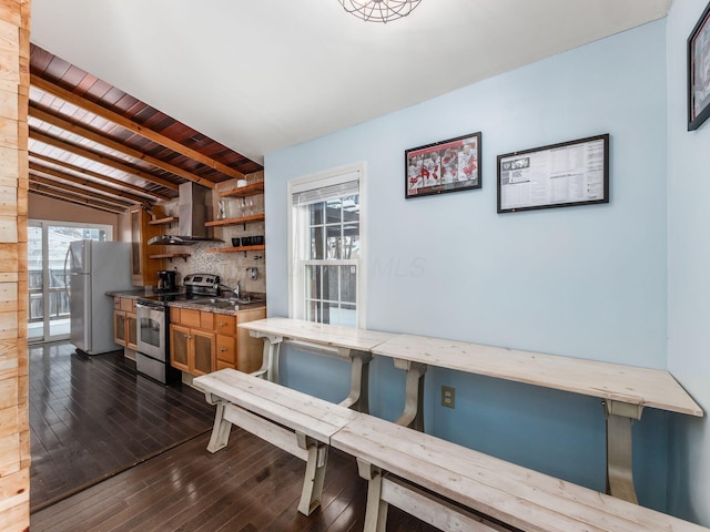 dining area featuring vaulted ceiling with beams, dark hardwood / wood-style floors, and wooden ceiling