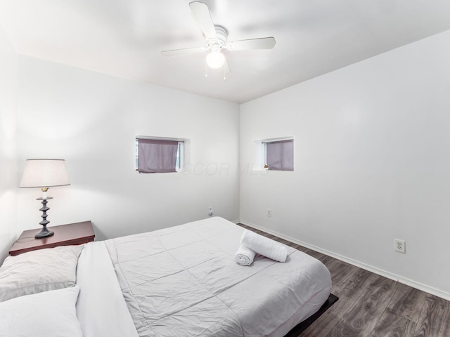 bedroom with ceiling fan and dark hardwood / wood-style flooring