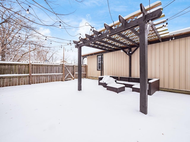 snowy yard with a pergola