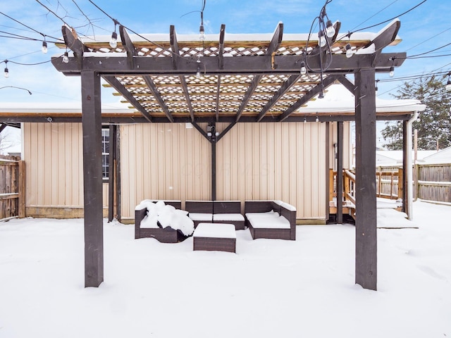 snow covered patio with outdoor lounge area and a pergola