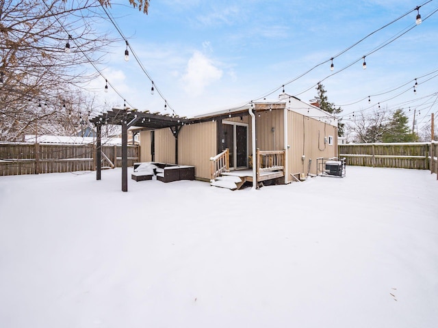 snow covered property featuring a pergola