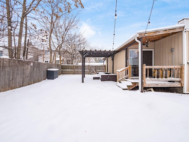 yard covered in snow with a pergola, a wooden deck, and cooling unit