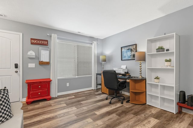 home office with hardwood / wood-style floors