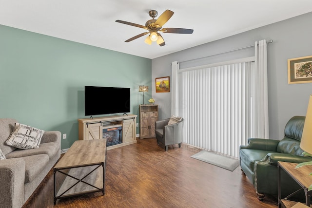 living room with dark wood-type flooring and ceiling fan