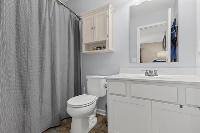 bathroom featuring toilet and vanity