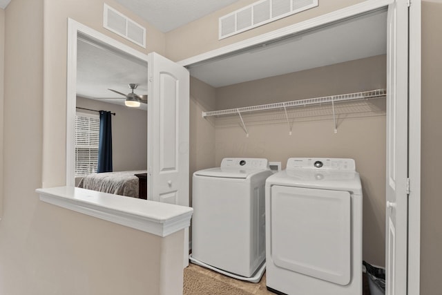 laundry room with ceiling fan, a textured ceiling, and washing machine and dryer