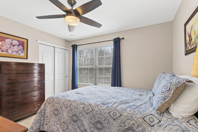 bedroom featuring ceiling fan and a closet