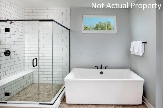 bathroom with shower with separate bathtub