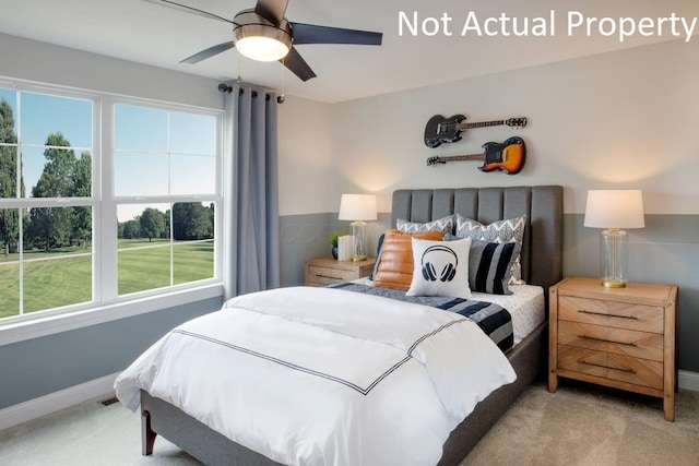 carpeted bedroom featuring ceiling fan and multiple windows