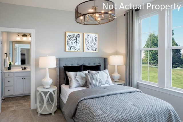 bedroom with an inviting chandelier and sink