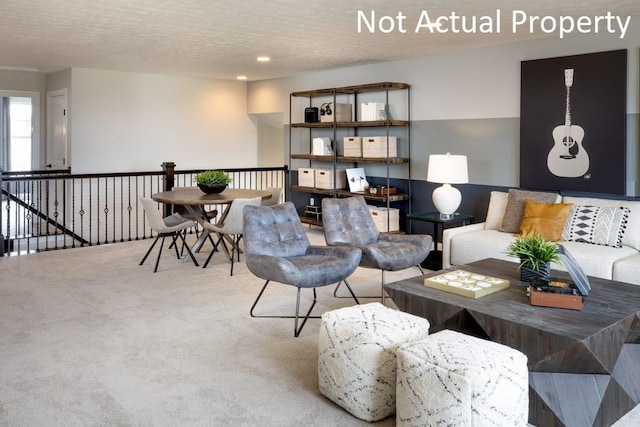 carpeted living room featuring a textured ceiling