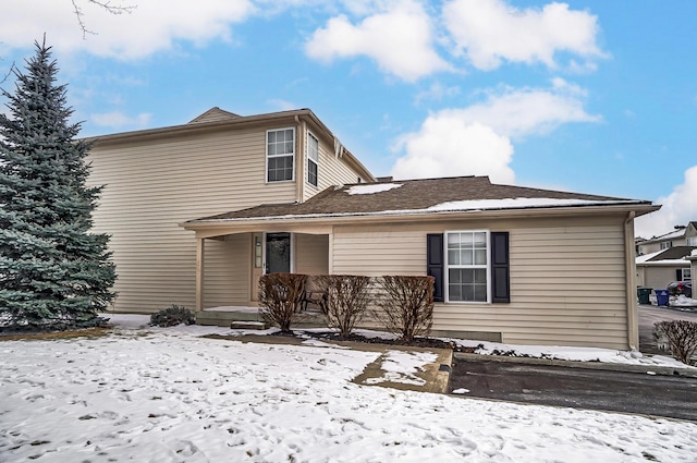 snow covered property featuring covered porch