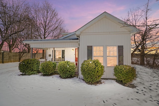 view of snow covered exterior with covered porch