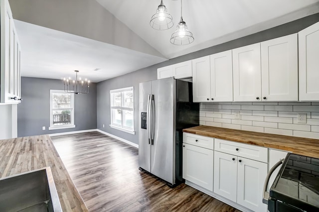 kitchen featuring black range oven, decorative backsplash, wood counters, and pendant lighting