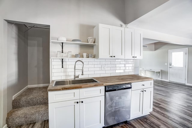 kitchen featuring white cabinetry, butcher block countertops, and stainless steel dishwasher