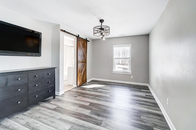 interior space with a barn door and light hardwood / wood-style flooring