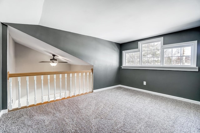 carpeted empty room with ceiling fan and lofted ceiling