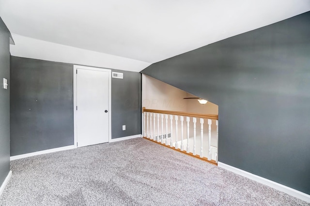 interior space with carpet flooring and vaulted ceiling