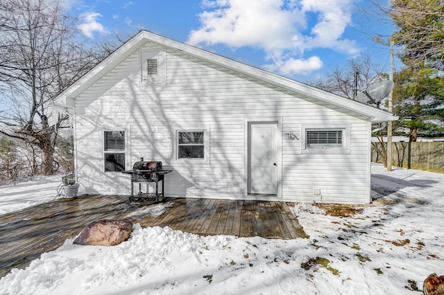 snow covered property featuring a deck