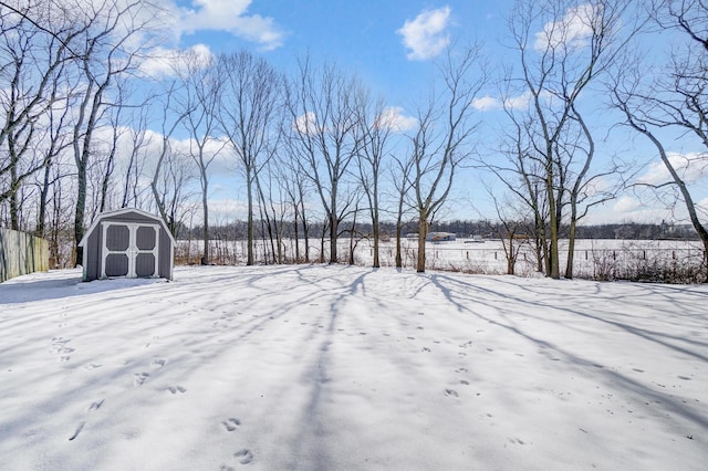 yard covered in snow with a storage unit