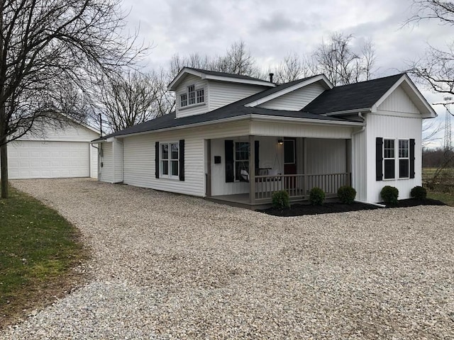 view of front facade with covered porch, a garage, and an outdoor structure