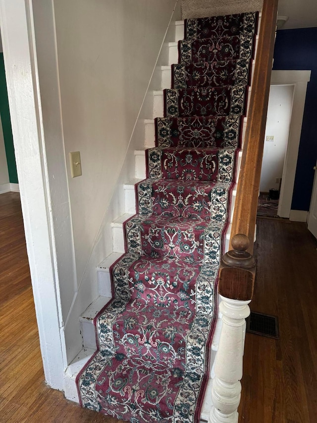 stairway with hardwood / wood-style floors